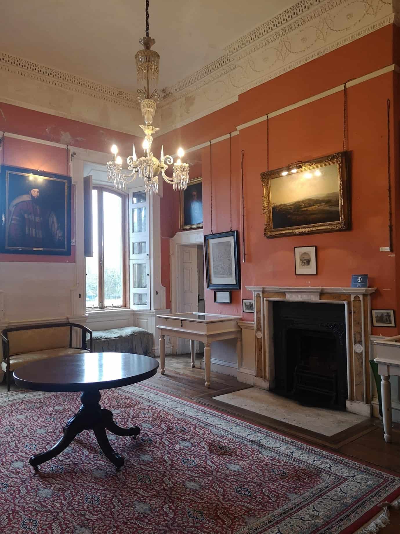 The Small Dining Room at Westport House - Howe Peter’s Coach Riding Whips either side of the J.A. O’Connor painting over the fireplace