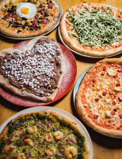 Try our delicious woodfire pizza at Gracy's pizzeria